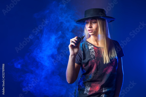 The girl smokes an electron...