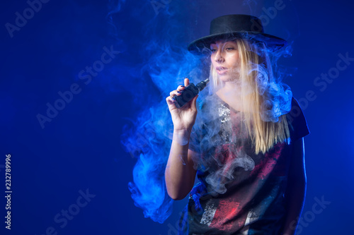 The girl smokes an electron...