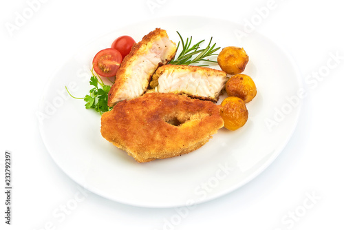 Delicious Battered Fish Fillet with herbs, pepper and tomatoes, isolated on a white background. Close-up