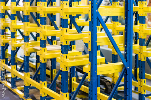 plastic boxes in the cells of the automated warehouse. Metal construction warehouse shelving © xiaoliangge