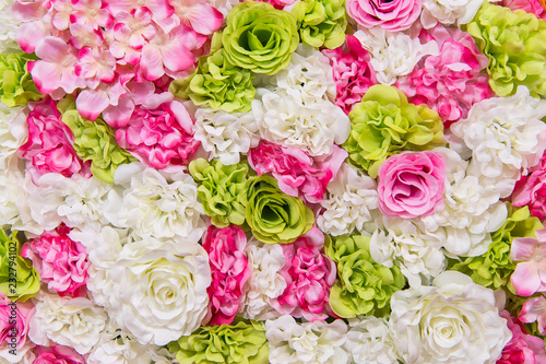 Beautiful multicolored artificial flowers background. flowers decor.