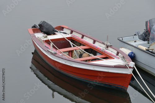 red wooden fishing boat moored