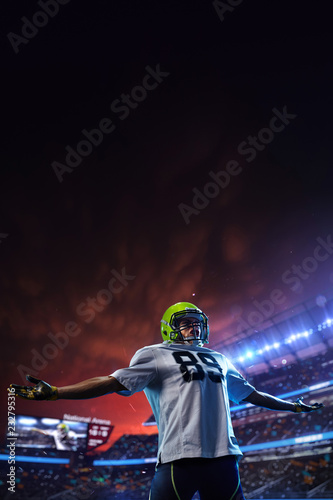 American football player celebrate tocuhdown on stadium. Sport wallpaper or advertising
