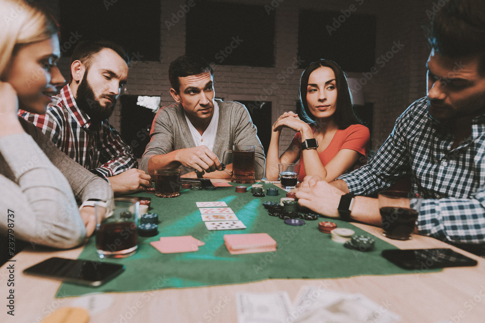 Young Friends Playing Poker on Party at Home.