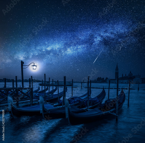 Swinging gondolas in Venice at night with stars, Italy