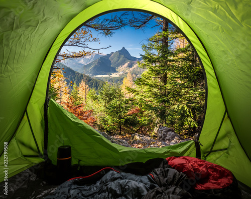 View from tent to Tatra mountains in autumn at sunrise