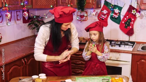 Mother teaches her daughter to work with sugar mastic for decorete cupcakes photo