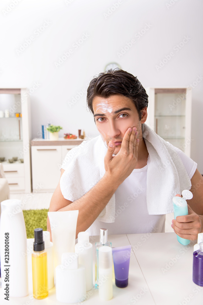 Young handsome man in the bathroom in hygiene concept 