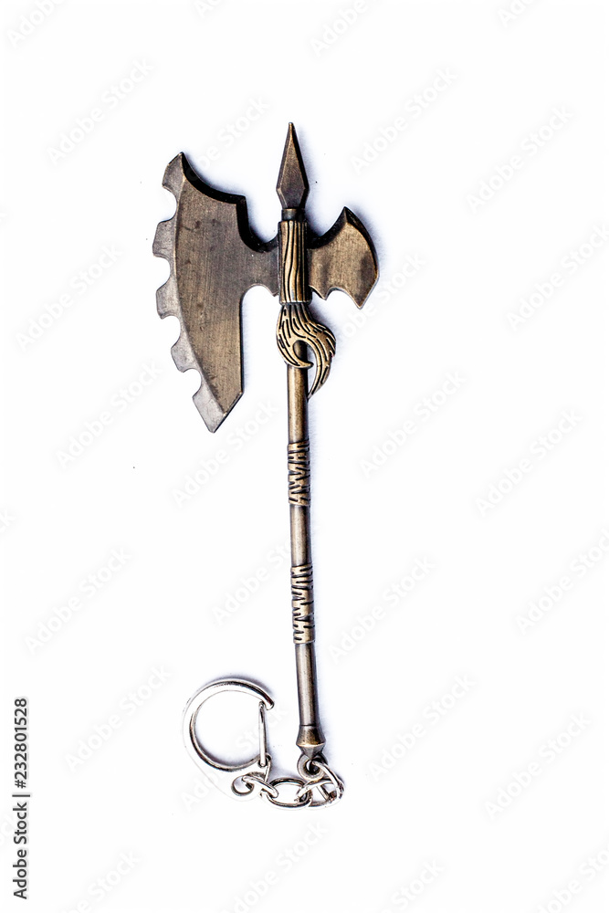 Close up of Axe key chain of golden color isolated on white. Close up of Axe key chain of golden color isolated on white.