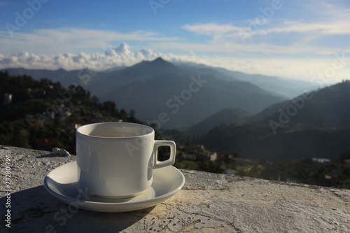 Cup of tea against the misty mountain