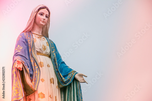 Virgin Mary statue with colourful background, Jesus christ mother. photo