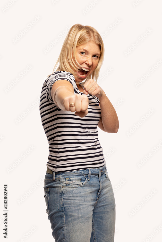 Young woman in fighting stance, isolated on white background Young woman in fighting stance, isolated on white background