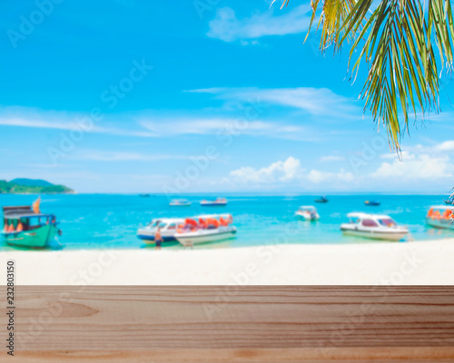 empty wooden tabletop on the white sandy beach background