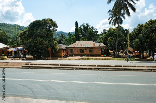 Dar es Salaam, Tanzania - July 9, 2018: House near road Man is running