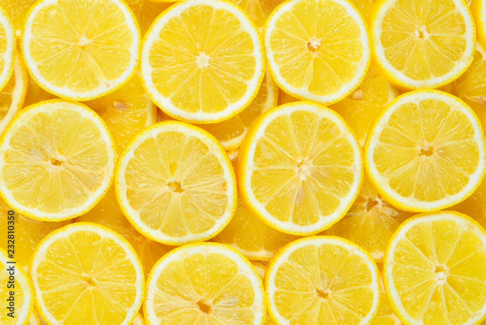 A slices of fresh juicy yellow lemons.  Texture background, pattern.