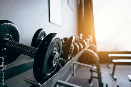 Dumbbell on barbell in club center fitness workout.