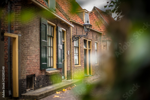 View on traditional Dutch houses and streets in a recreated heritage museum with beautiful historic vintage scenes from Holland. photo