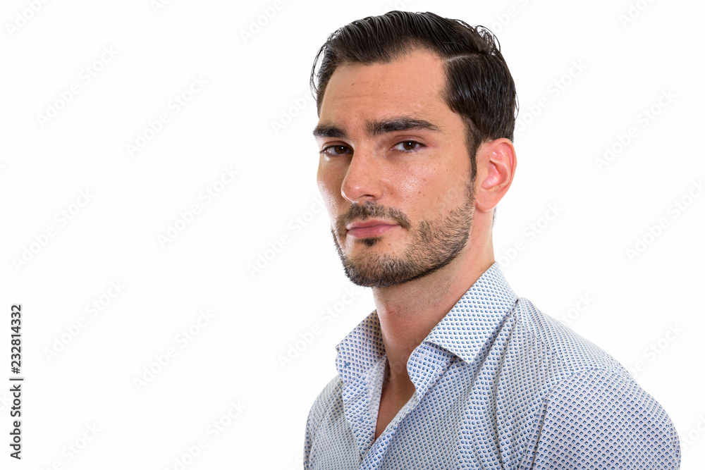 Studio shot of young handsome businessman looking at camera Studio shot of young handsome businessman looking at camera