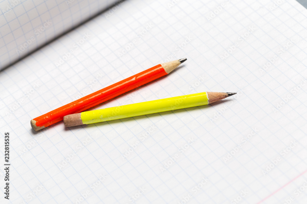 Pencils and notepad paper sheets on gray desk table Pencils and notepad paper sheets on gray desk table