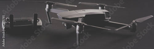 Remote control flying drone and flying drones on black background © Rakursstudio