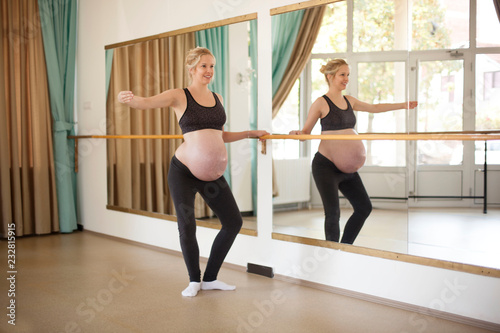 Young beautiful pregnant woman on yoga, pilates and ballet class