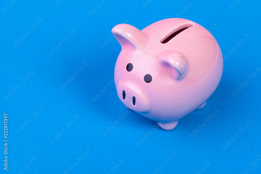 Pinik piggy bank on bright colored background