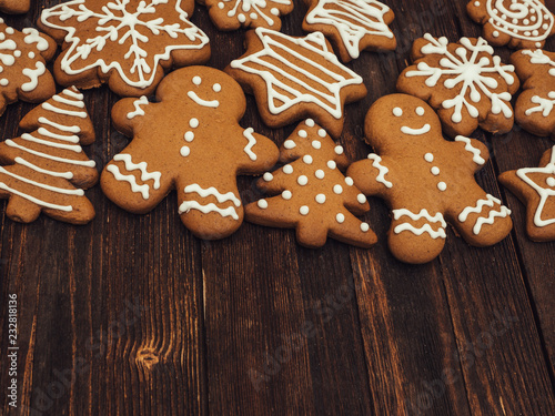 Happy New Year and Merry Christmas gingerbread on wood background. Christmas baking. Making gingerbread christmas cookies. Christmas concept.