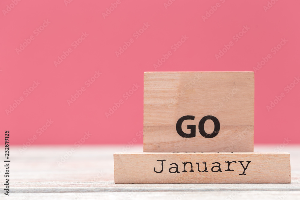 Wooden cubes with text on table over pink background with copy space for text Wooden cubes with text on table over pink background with copy space for text