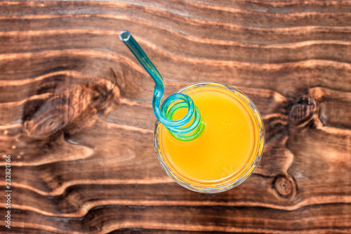 cups with mango juice on wooden countertop, top view