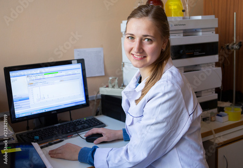 Young scientist works in modern biological lab photo