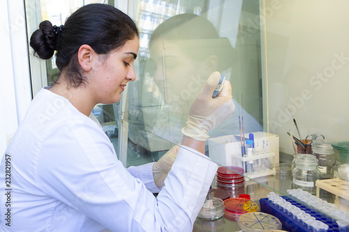 Young scientist works in modern biological lab photo