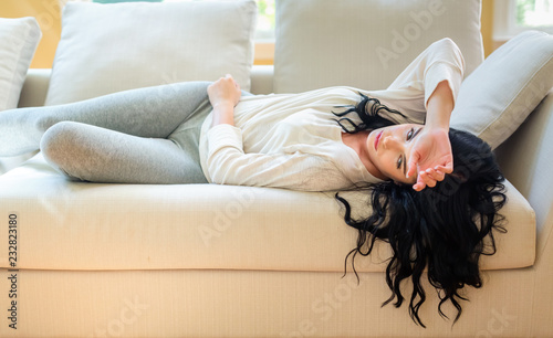 Sick young woman with a fever or illness in her home