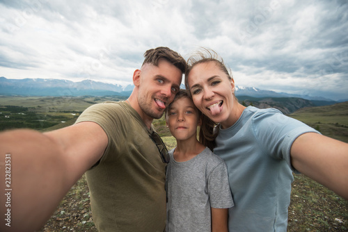 Selfie of family in mountain, beauty summer landcape © olinchuk