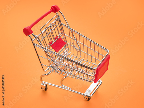 Small shopping cart on orange