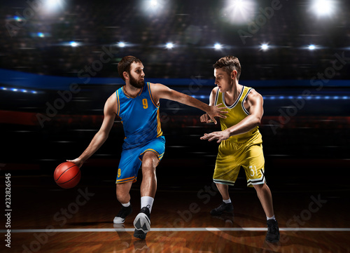 two basketball players in scrimmage during basketball match