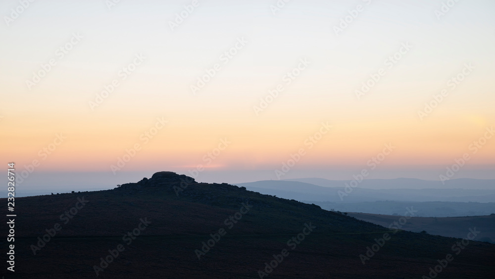 Stunning sunset silhouette landscape image of Foggintor in Dartmoor