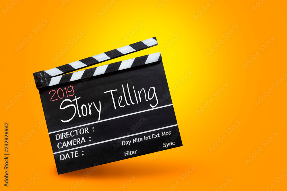 Naklejka premium 2019 story telling ,text title on movie Clapper board on orange colour backgrounds