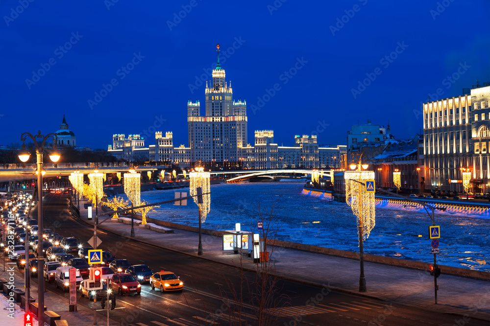 View of the night winter Moscow with the Moscow river and high-rise building on Kotelnicheskaya embankment. Russia