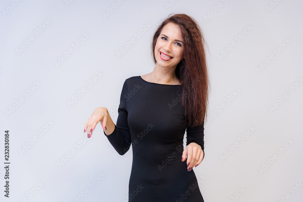 Studio portrait concept of a smiling beautiful brunette girl talking on a white background. Studio portrait concept of a smiling beautiful brunette girl talking on a white background.
