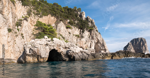 Caves in the cliffs on the island of Capri in the Bay of Naples, Italy. Photographed whilst on a boat trip around the island. photo