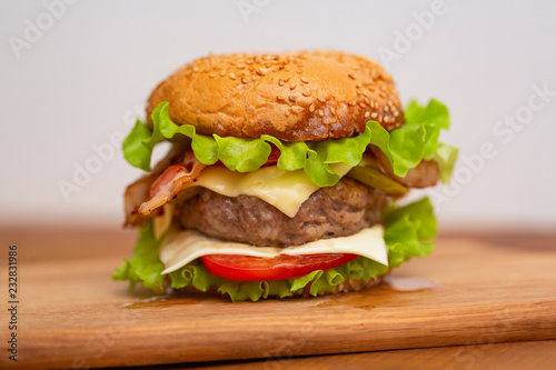 Fresh tasty burger on wood table