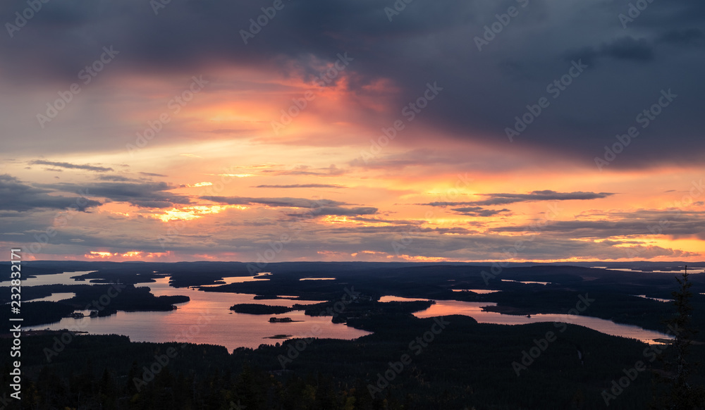 Scenic sunset landscape with high angle view and lakes at autumn evening in Lapland, Finland