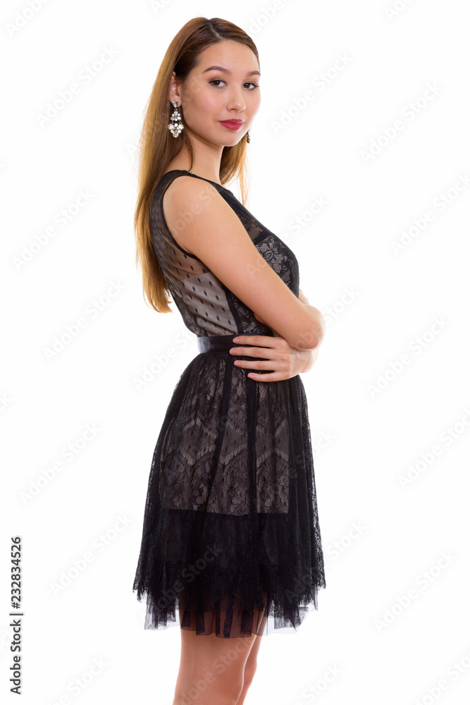 Studio shot of young beautiful Asian woman standing with arms cr Studio shot of young beautiful Asian woman standing with arms cr