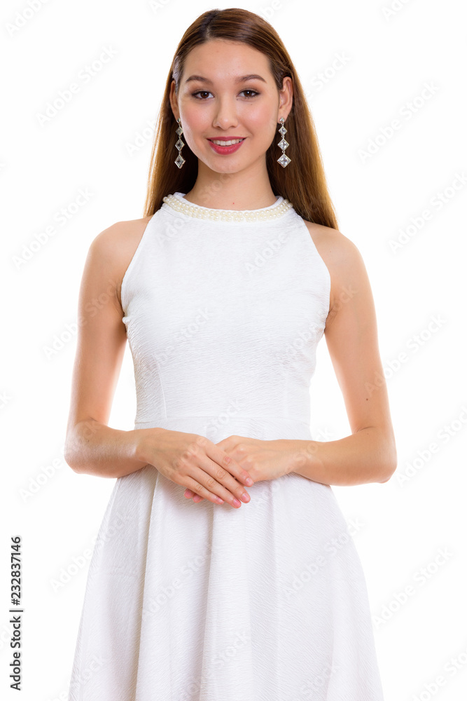Studio shot of young happy beautiful Asian woman smiling with ha Studio shot of young happy beautiful Asian woman smiling with ha