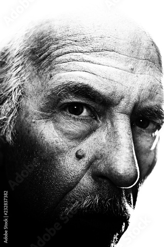 Fotografie Highly detailed, high contrast, close up, black and white portrait of man with head turned looking at viewer