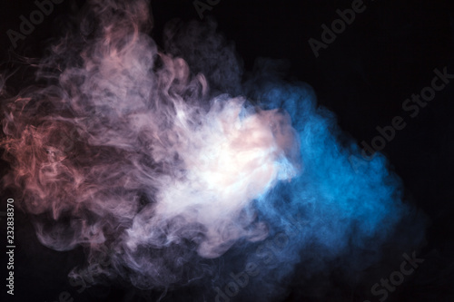 Colored smoke on a black background. The concept of light show at a music concert