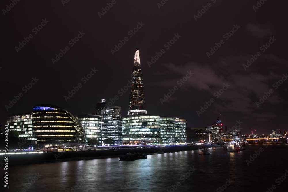 Skyline of London with the lightning Sharp and the modern buildings of the business district along the river Thames