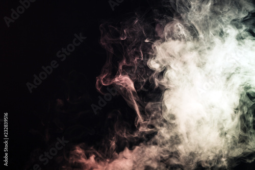 Colored smoke on a black background. The concept of light show at a music concert