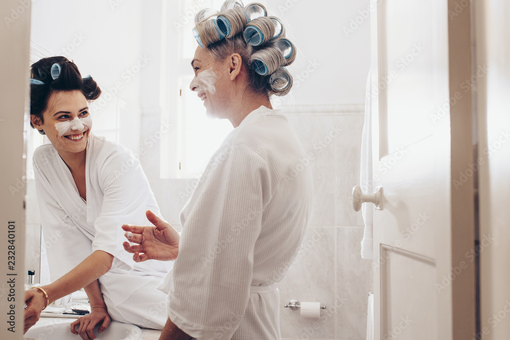 Obraz premium Two women having fun while grooming at home