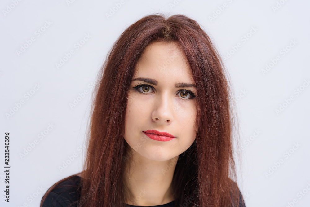 Studio portrait concept of a smiling beautiful brunette girl talking on a white background. Studio portrait concept of a smiling beautiful brunette girl talking on a white background.